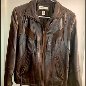 Women’s small brown leather jacket. Casual and edgy with zippers on sleeves.